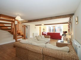A living room with a staircase and seating area at The Wainhouse in Bockleton near Tenbury Wells