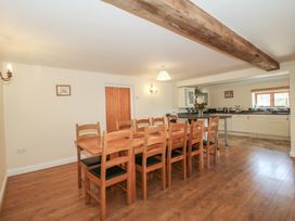 A dining room with a wooden table and chairs at The Wainhouse in Bockleton near Tenbury Wells