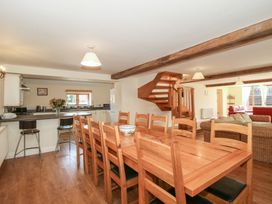 A dining room with a large table and chairs at The Wainhouse in Bockleton near Tenbury Wells