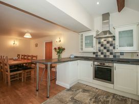 A kitchen with dining area and appliances at The Wainhouse in Bockleton near Tenbury Wells