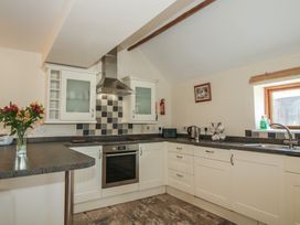 A kitchen with appliances and cabinets at The Wainhouse in Bockleton near Tenbury Wells