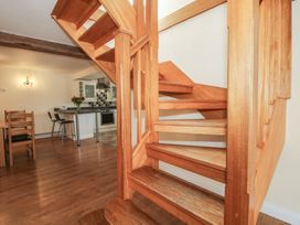 A staircase in a kitchen with a dining table and chairs at The Wainhouse in Bockleton near Tenbury Wells