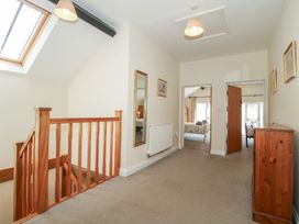 A hallway with stairs and a mirror at The Wainhouse in Bockleton near Tenbury Wells