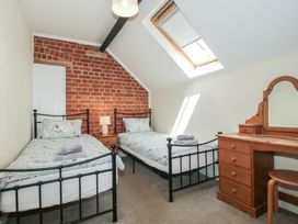 A bedroom with two single beds and a dressing table at The Wainhouse Bockleton near Tenbury Wells