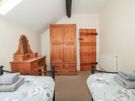 A bedroom with a wardrobe and dressing table at The Wainhouse in Bockleton near Tenbury Wells