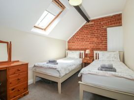A bedroom with two beds and a dresser at The Wainhouse in Bockleton near Tenbury Wells