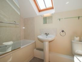 A bathroom with a bathtub and sink at The Wainhouse in Bockleton near Tenbury Wells