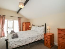 A bedroom with a bed and furniture at The Wainhouse in Bockleton near Tenbury Wells