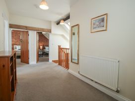 A hallway with staircase and mirror at The Wainhouse in Bockleton near Tenbury Wells
