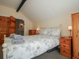 A bedroom with a bed and bedside table at The Wainhouse in Bockleton near Tenbury Wells