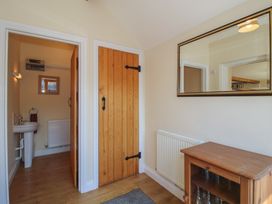 A hallway with wooden cabinet and mirror at The Wainhouse in Bockleton near Tenbury Wells