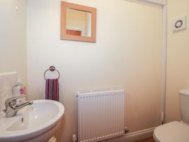 A bathroom with a sink, toilet, and towel rack at The Wainhouse Bockleton near Tenbury Wells