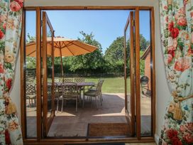 A view of a patio area with a table and chairs at The Wainhouse in Bockleton near Tenbury Wells