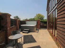 An outdoor area with a hot tub and seating at The Wainhouse Bockleton near Tenbury Wells