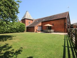A house with a garden and patio seating area at The Wainhouse Bockleton near Tenbury Wells