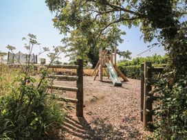 A playground with a slide and picnic table at The Wainhouse in Bockleton near Tenbury Wells