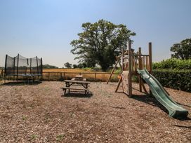 An outdoor play area with a slide and trampoline at The Wainhouse Bockleton near Tenbury Wells