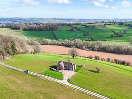 An aerial view of a house surrounded by fields at Wood Cottage in Tenbury Wells