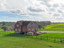 A house with a driveway and fencing in a field at Wood Cottage Tenbury Wells