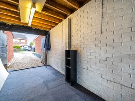 A garage with open doors and a shelf at Wood Cottage in Tenbury Wells