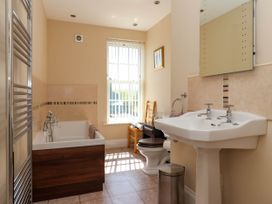 A bathroom with a bathtub sink toilet and window at Foremans House in Bridlington