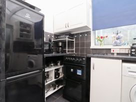 A kitchen with appliances and storage space at Merlin in Llithfaen near Nefyn
