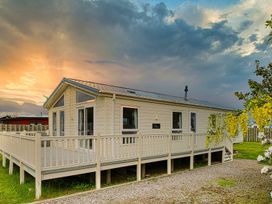 A house with a deck and garden at Cheri in Southerness