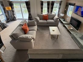A living room with two sofas and a coffee table at Cheri in Southerness