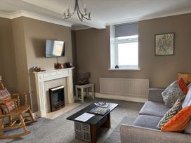 A living room with a sofa and television at Greenmantle in Skinburness near Silloth Solway Firth