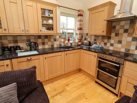 A kitchen with cabinets and appliances at West Gate in Embleton