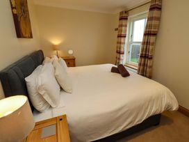 A bedroom with a bed and bedside table at West Gate in Embleton