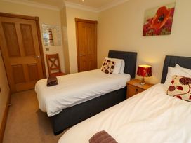 A bedroom with two single beds and a nightstand at West Gate in Embleton