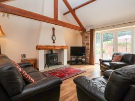 A living room with a fireplace and television at Winsall Court I Gransmoor near Bridlington