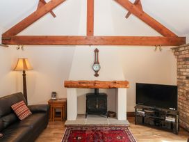 A living room with a fireplace and a television at Winsall Court I in Gransmoor near Bridlington
