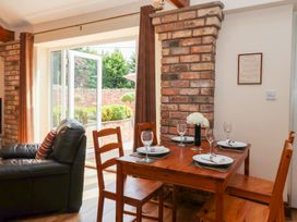 A dining room with a table and chairs at Winsall Court I in Gransmoor near Bridlington