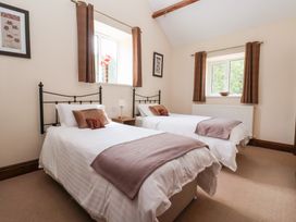 A bedroom with two single beds and a window at Winsall Court I Gransmoor near Bridlington