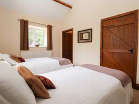 A bedroom with two beds and a window at Winsall Court I Gransmoor near Bridlington