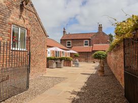 An outdoor space with a seating area and potted plants at Winsall Court I Gransmoor near Bridlington