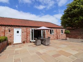 An outdoor patio with a table and chairs at Winsall Court II Gransmoor near Bridlington