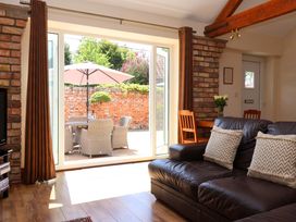 A living room with a view to a patio at Winsall Court II Gransmoor near Bridlington