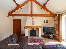 A living room with a fireplace and television at Winsall Court II Gransmoor near Bridlington