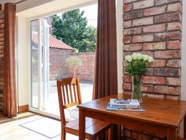 A dining area with a table and chairs at Winsall Court II Gransmoor near Bridlington