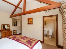 A bedroom with a bed and attached bathroom at Winsall Court II Gransmoor near Bridlington
