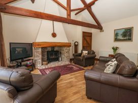 A living room with a fireplace and television at The Wagon Shed in Gransmoor near Bridlington
