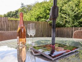 A table with a bottle of wine and glasses at The Wagon Shed Gransmoor near Bridlington