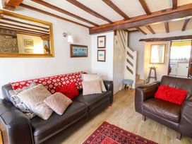 A living room with a sofa and cushions at Chancery Cottage Hay-On-Wye