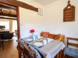 A dining room with a table set for tea at Chancery Cottage in Hay-On-Wye