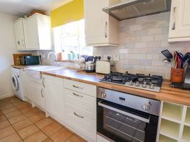 A kitchen with appliances and a sink at Chancery Cottage in Hay-On-Wye