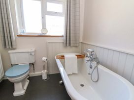 A bathroom featuring a bathtub and toilet at Chancery Cottage in Hay-On-Wye