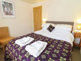 A bedroom with a bed and towels at Chancery Cottage in Hay-On-Wye